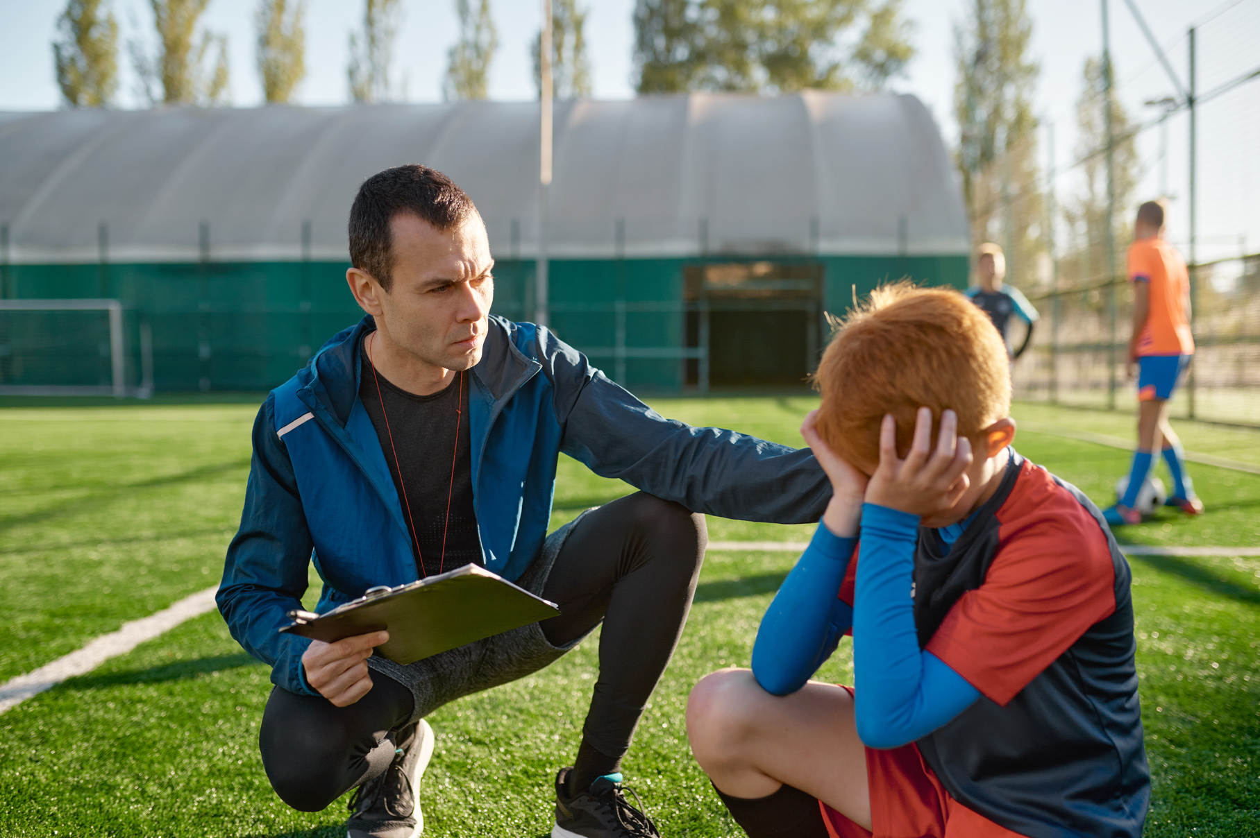 Coach Comforting Crying Little Soccer Player after Missed Goal